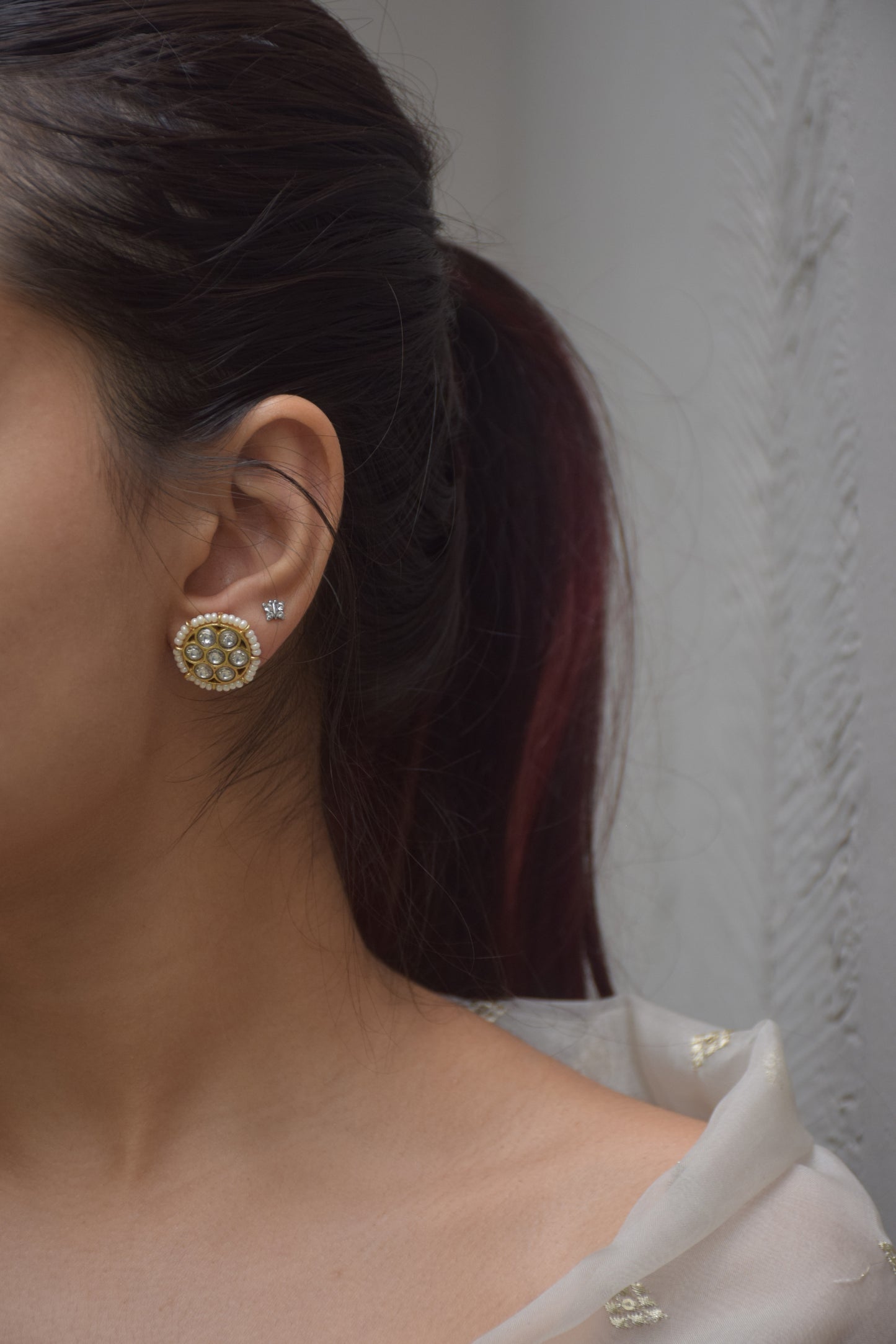 Handcrafted 925 silver Mogra Earstuds with gold finish, adorned with Jadau stones and seed pearls, perfect for bridal, ethnic, and traditional occasions.