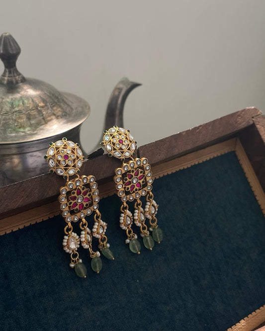 crafted earrings in 92.5 sterling silver, featuring traditional Jadau work with multicolored stones, a floral motif centerpiece, and intricate petal detailing.