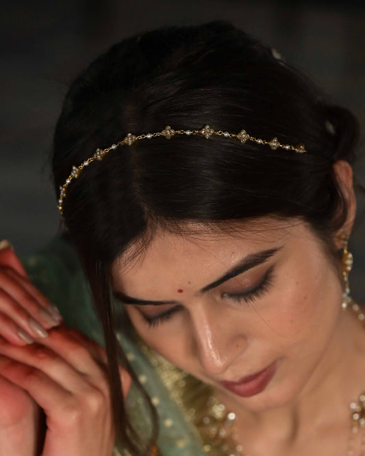 Najariya Mattha Patti handcrafted in 925 silver with gold polish, featuring intricate 4-petal floral motifs accented with freshwater pearls.