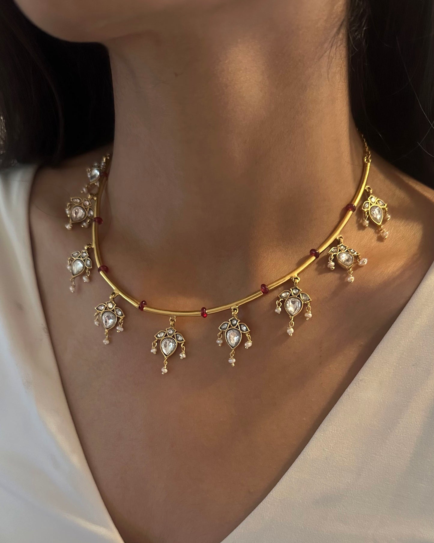 Noorika silver hasli necklace with flexible design, pink beads, floral motifs, and freshwater pearl drops.