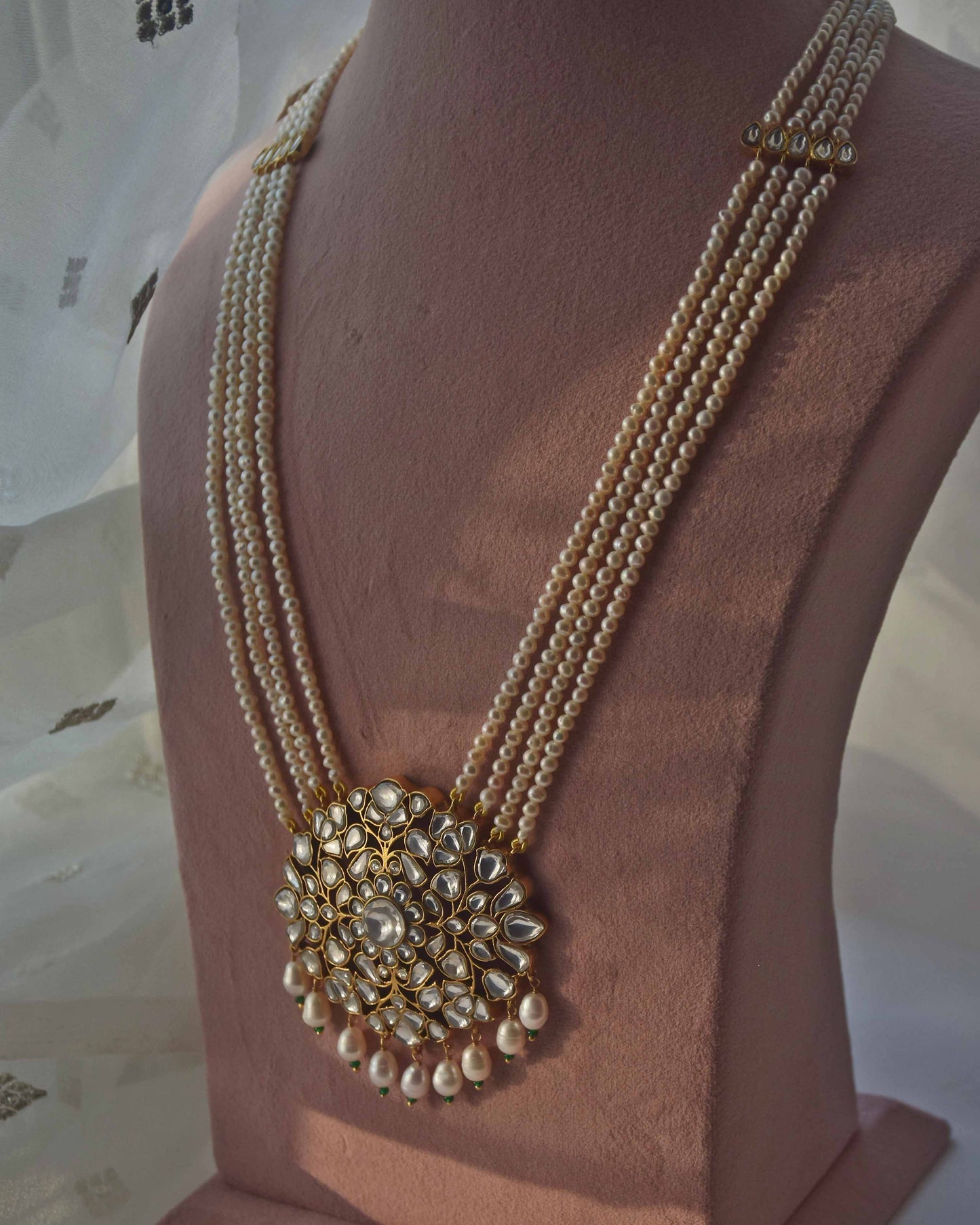 Gulnaar necklace by Nuvi Jewels featuring a jadau stone-studded floral and leaf pendant with pearl strands