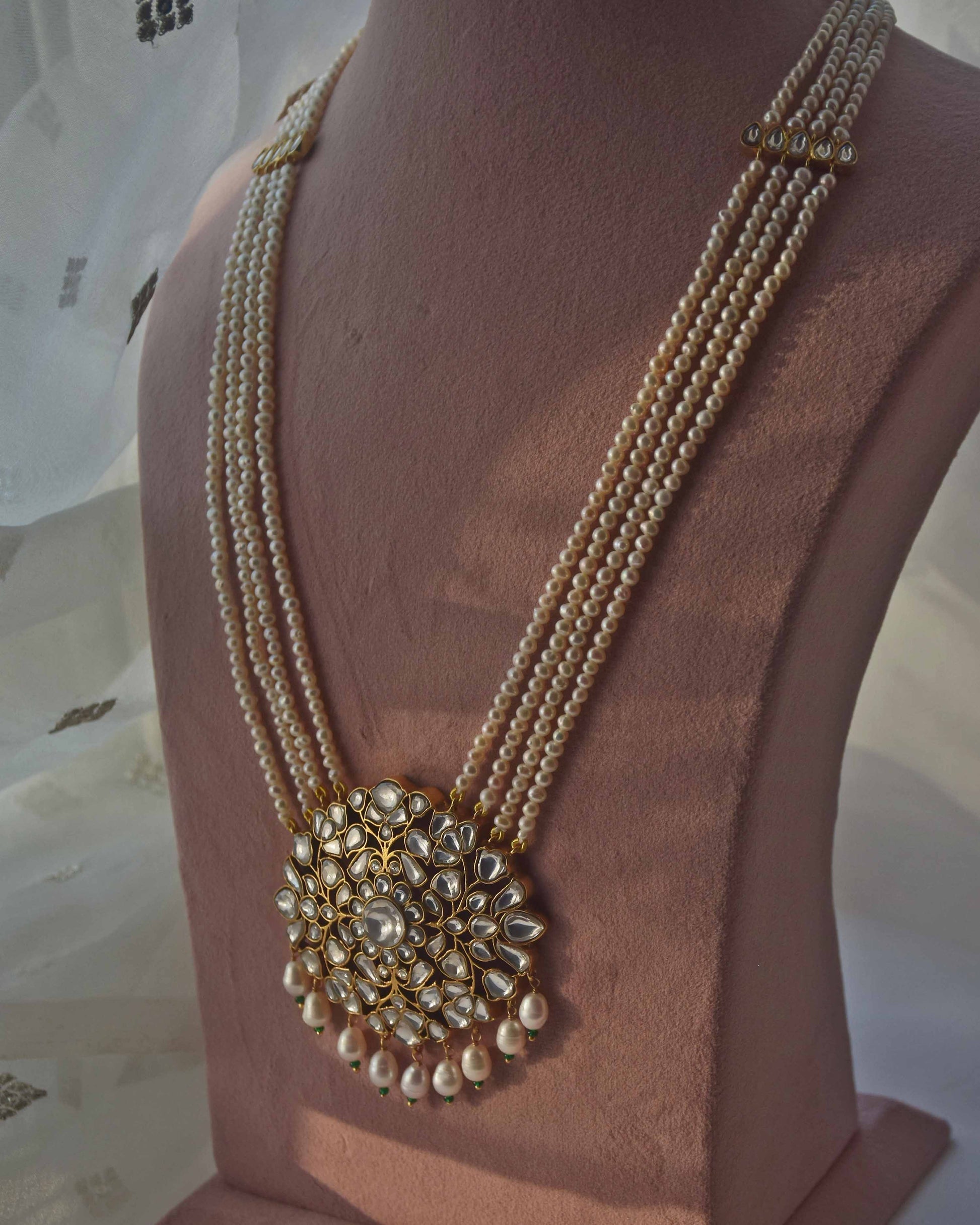 Gulnaar necklace by Nuvi Jewels featuring a jadau stone-studded floral and leaf pendant with pearl strands