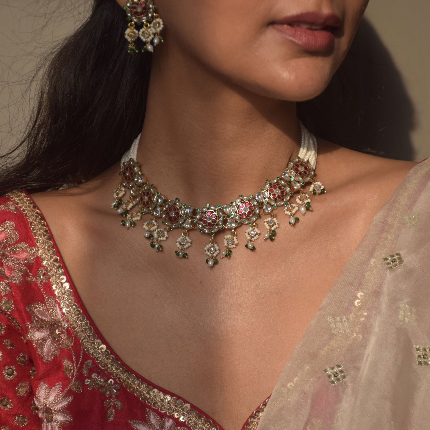 Handcrafted 925 silver Ranisa choker with Jadau work, multi-colored stones, and delicate pearl strands, reflecting India’s rich heritage.”
