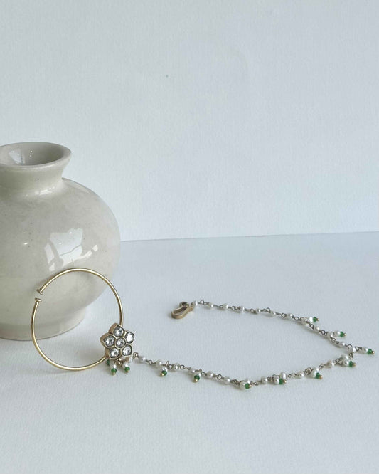 Handcrafted Shringaari Nath nose ring in sterling silver, gold plated with traditional Kundan and detailed Jadau craftsmanship Jewellery made of sterling silver bearing the 925 mark
