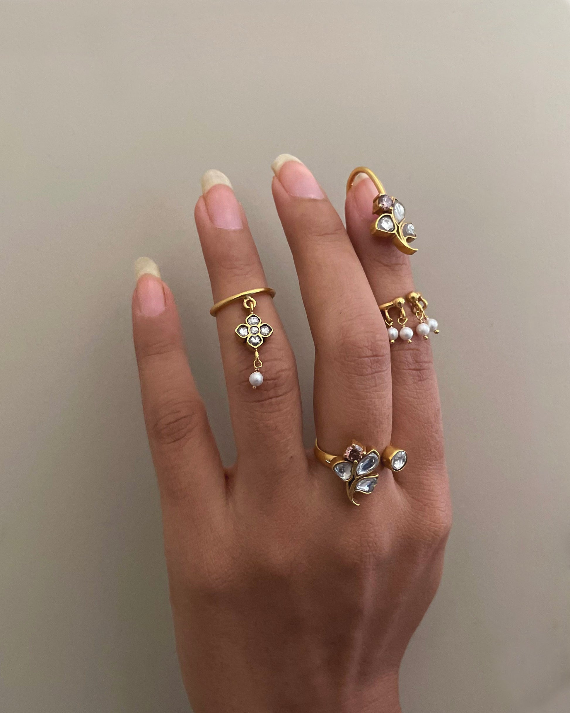 “Nuvi Jewels designer Rasa Mid Ring in 92.5 silver with delicate jadau motif and hanging pearl detail