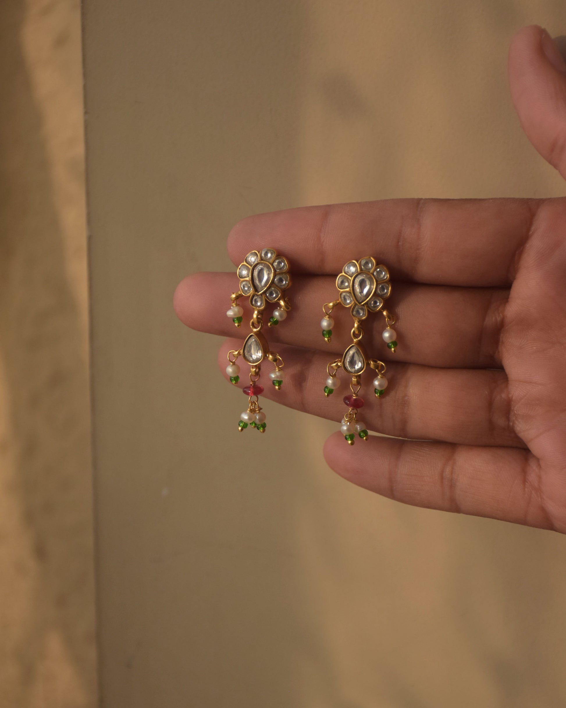 Statement Nuvi Jewels Sagrika Earrings in 92.5 silver gold plated featuring gold drop motifs with jadau stones