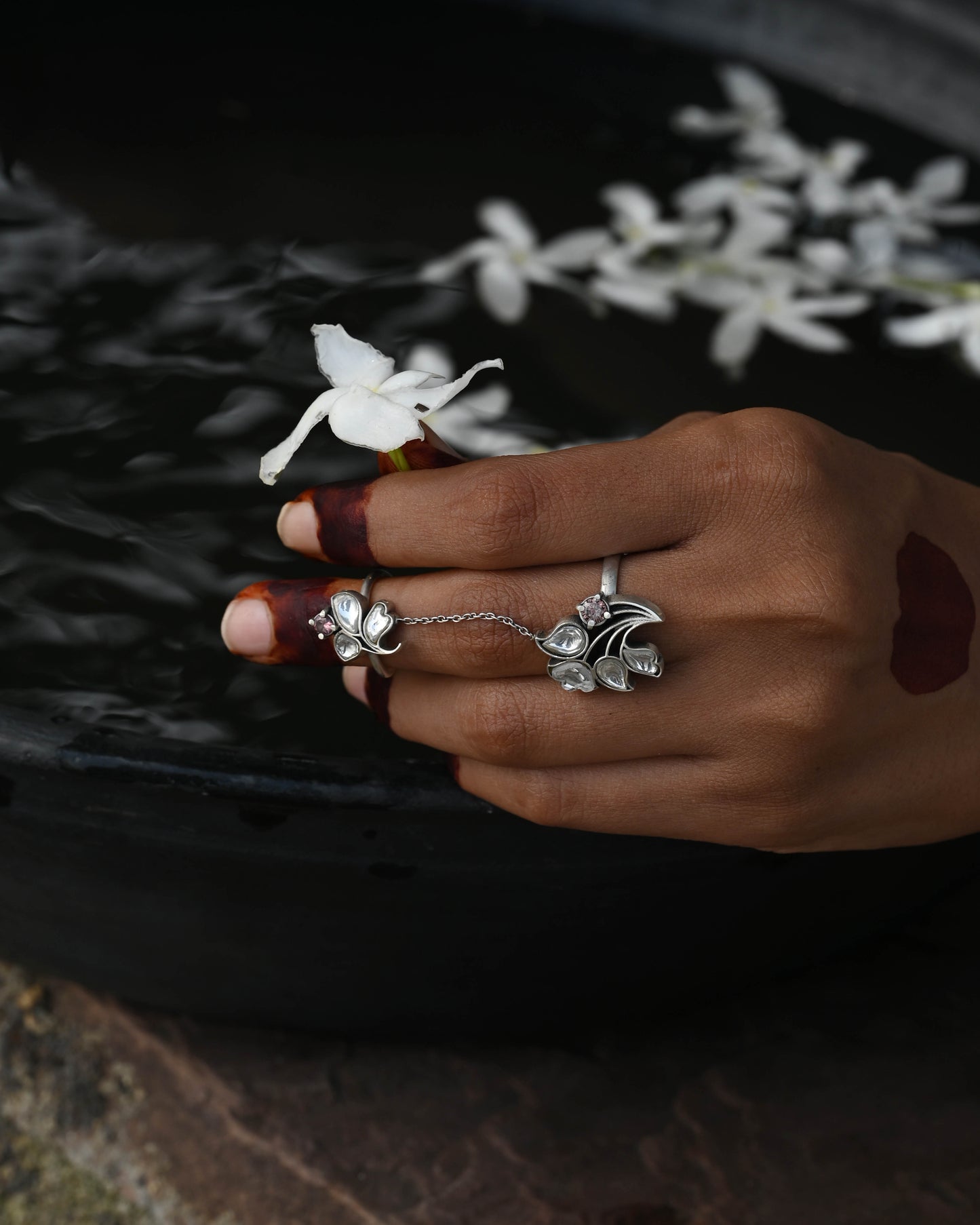 Nuvi Jewels Tarini Ring in 92.5 sterling silver gold plated with two adjustable rings connected by chain and floral jadau motifs