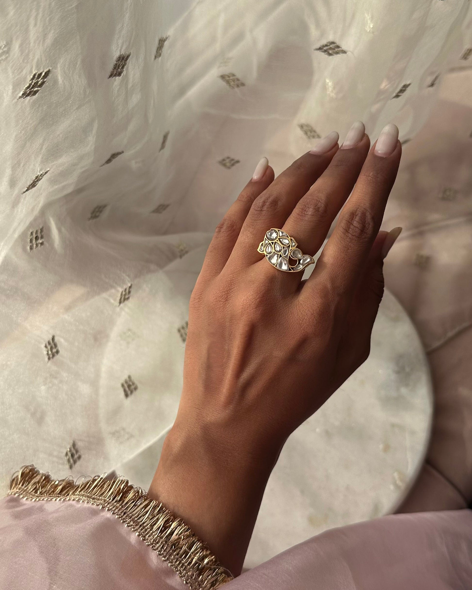 Matsya Ring- Crafted in 92.5 Gold Plated Silver has a fish motif that is studded with white jadau stones