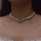 
"Nuvi Matsya Necklace in 925 silver featuring an intricately crafted fish motif adorned with white jadau stones, framed by delicate lines of lustrous shell pearls.