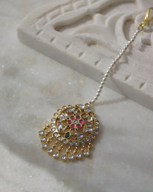 Paheli Maangtika handcrafted in 925 silver, featuring intricate floral motifs with green, pink, and white Jadau stones and cascading Jadau stone drops.