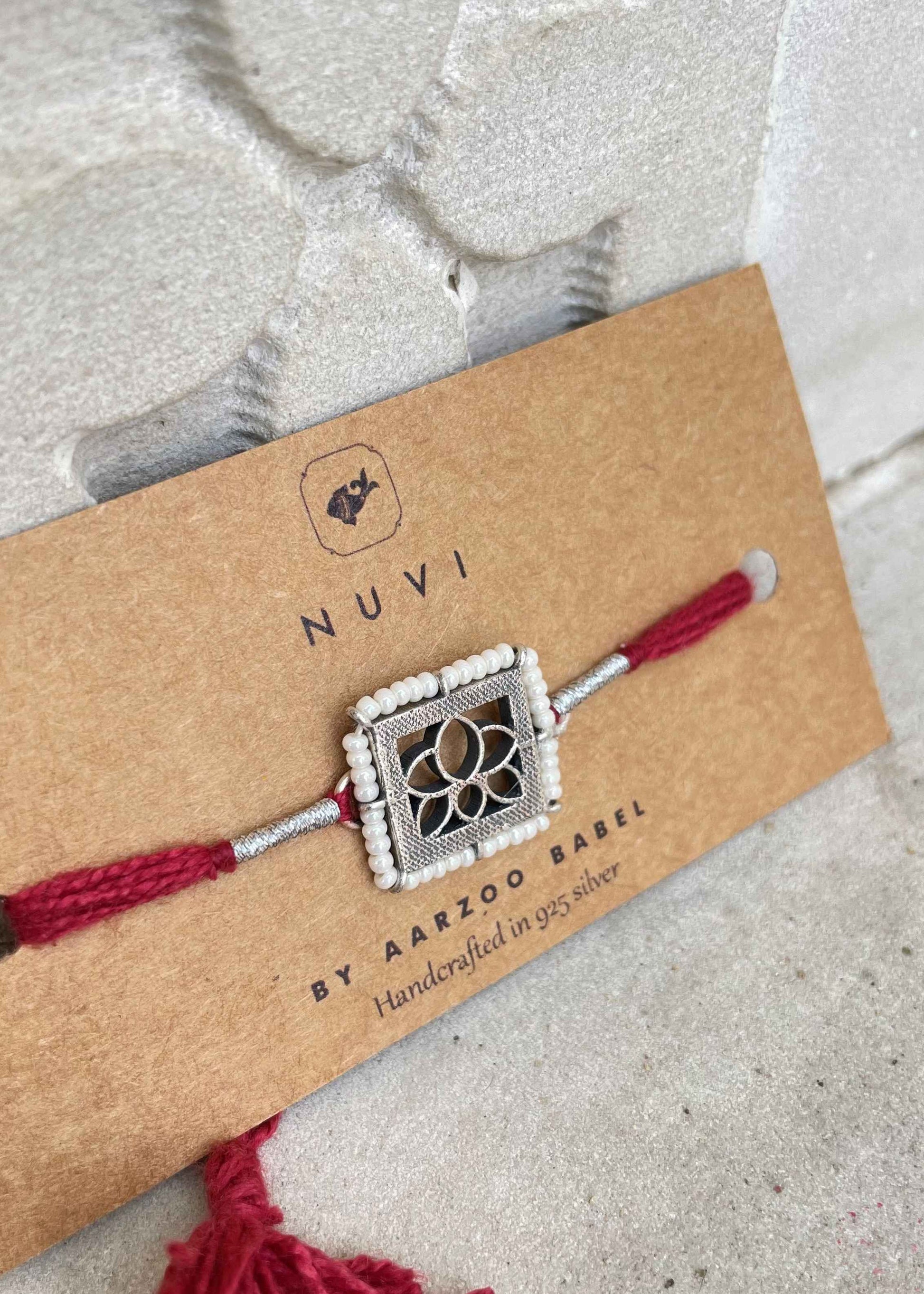 Handmade Kamal rakhi crafted in sterling silver with delicate floral detailing