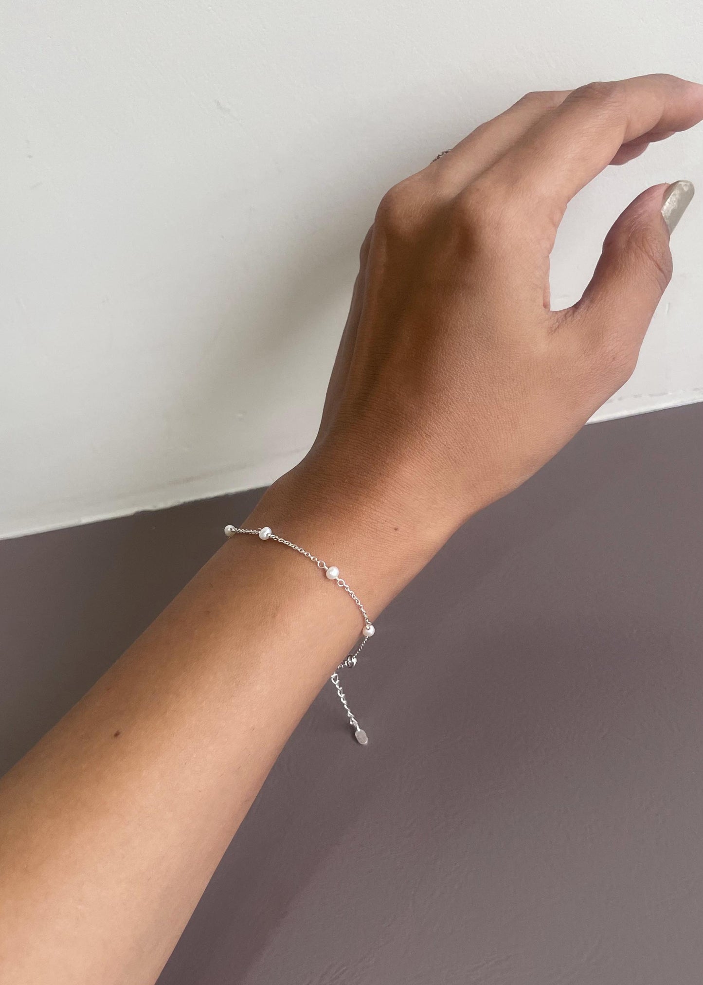 Fine crafted Freshwater Pearl bracelet featuring intricate silver detailing and pearl accents