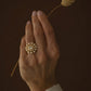 Statement Taarika ring featuring handcrafted floral design with light-catching polki stones on a gold-plated silver jewelry base.