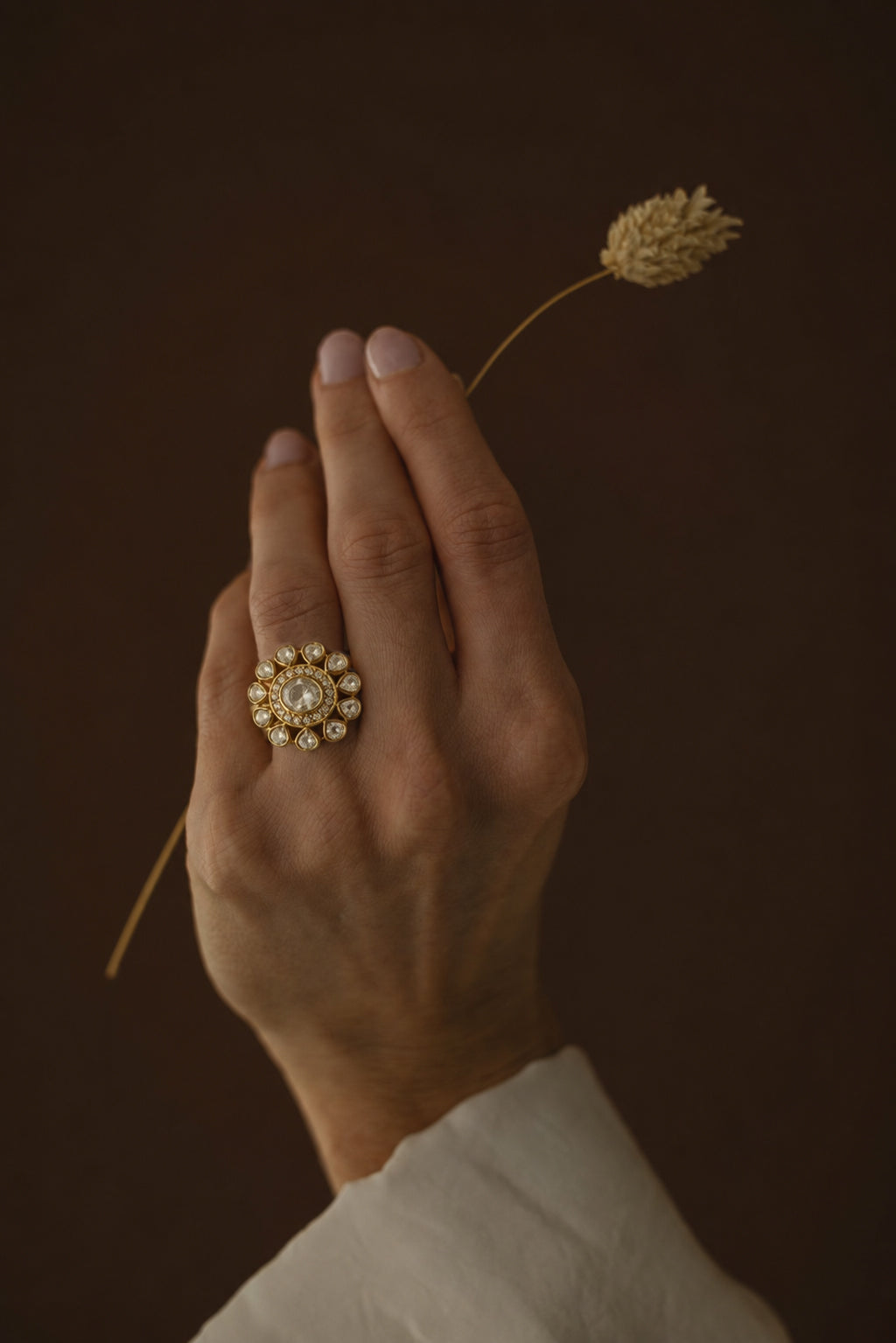 Statement Taarika ring featuring handcrafted floral design with light-catching polki stones on a gold-plated silver jewelry base.