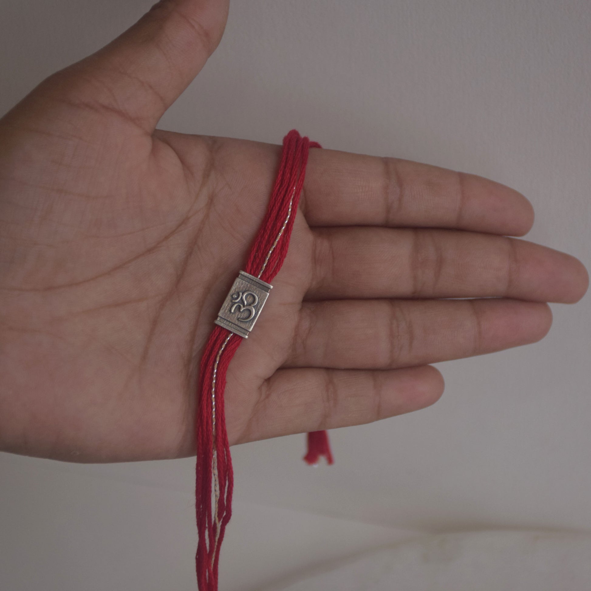Handmade Om rakhi in sterling silver