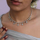 Madhura Hasli necklace crafted in 92.5 sterling silver, featuring delicate floral motifs and dangling pearls.