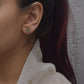 Raatrani 925 silver earstuds with 22k gold plating and delicate Jadau stone-studded flower motif.