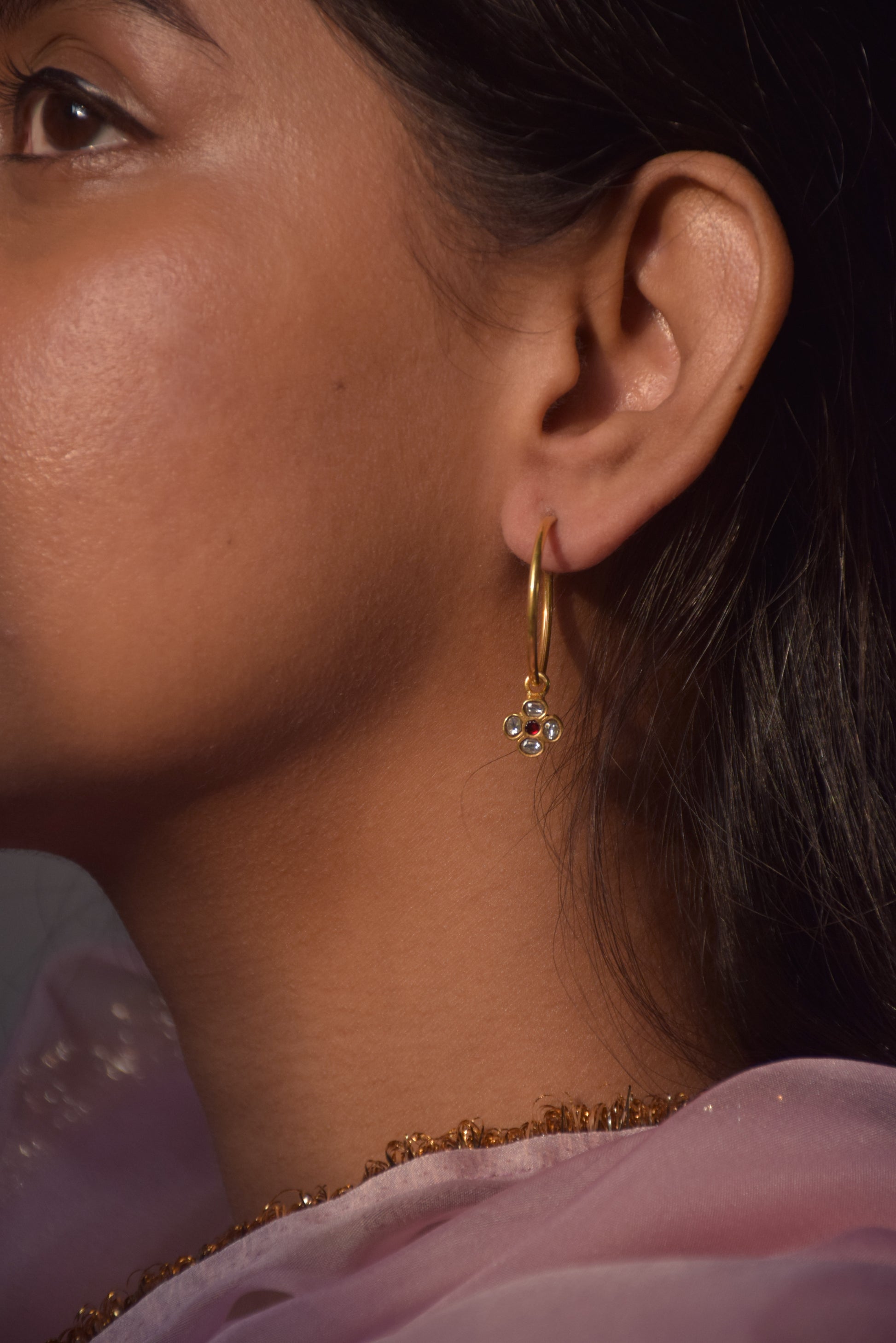 Raatrani Hoop Earrings crafted from 925 silver with 22-carat gold plating, featuring a 4-petal Jadau stone-studded flower motif hanging from the hoop.
