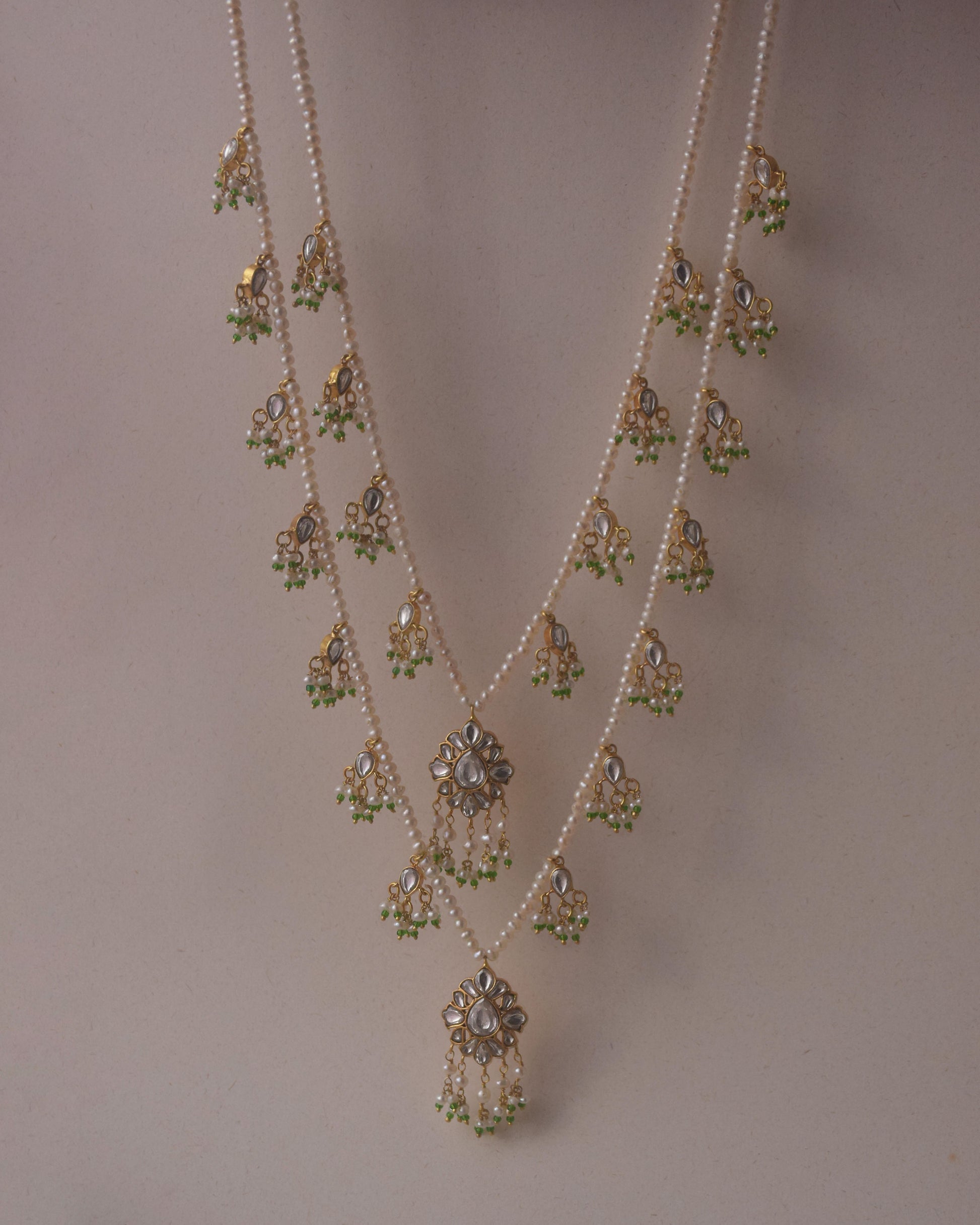 Radharani two-line ranihaar necklace handcrafted in 925 sterling silver, featuring lustrous freshwater pearls and hanging Jadau-studded units.