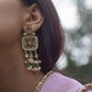 Regal statement earrings handcrafted in 92.5 sterling silver, inspired by Rajasthani heritage and adorned with traditional jadau stones. 