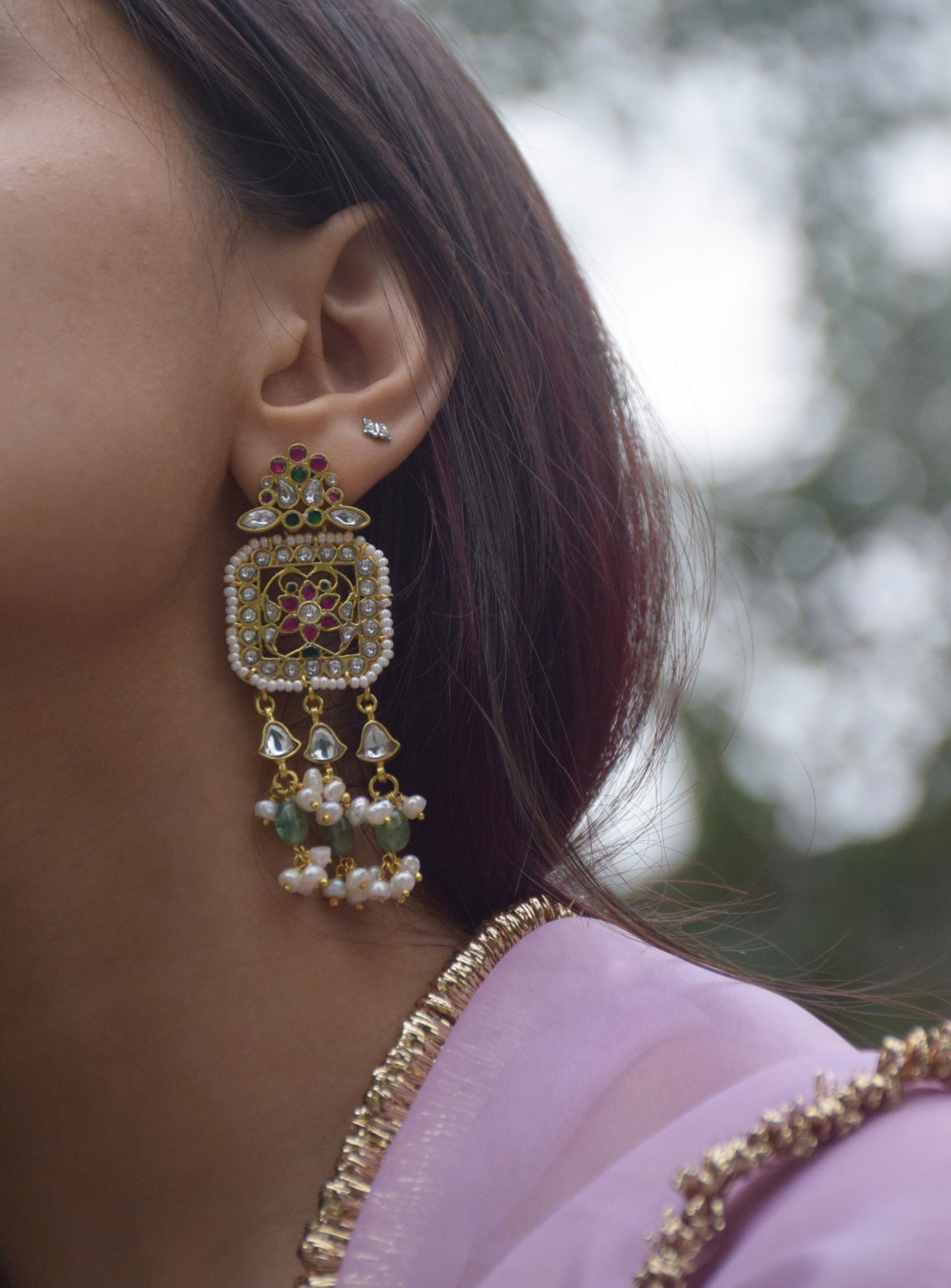 Regal statement earrings handcrafted in 92.5 sterling silver, inspired by Rajasthani heritage and adorned with traditional jadau stones. 