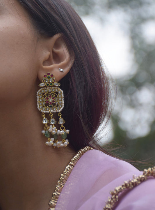 Regal statement earrings handcrafted in 92.5 sterling silver, inspired by Rajasthani heritage and adorned with traditional jadau stones. 