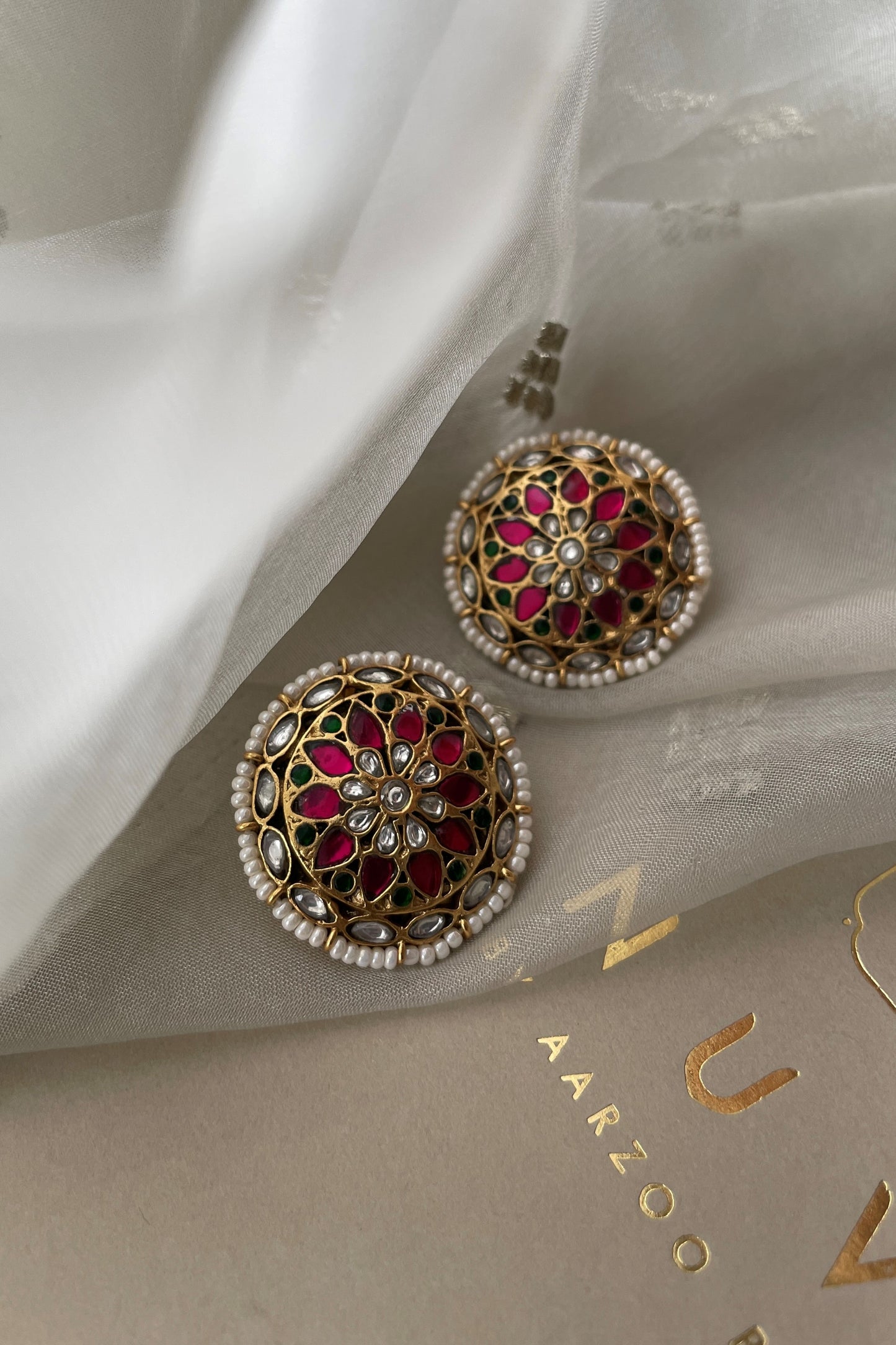 Handcrafted 925 silver Ranisa Earstuds with gold finish, adorned with intricate Jadau stones and pearl borders, perfect for weddings, festive occasions, or traditional Indian attire.