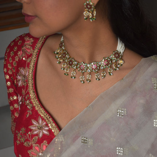 SEO-Friendly Alt Text:
"Ranisa Jadau Necklace in 925 silver with gold finish, featuring intricate traditional jadau work with multi-colored stones and delicate seed pearl strings.