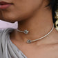 Rasini Hasli necklace handcrafted in 92.5 sterling silver, featuring twin floral motifs facing each other – elegant and versatile Indian jewelry inspired by traditional Hasli design.