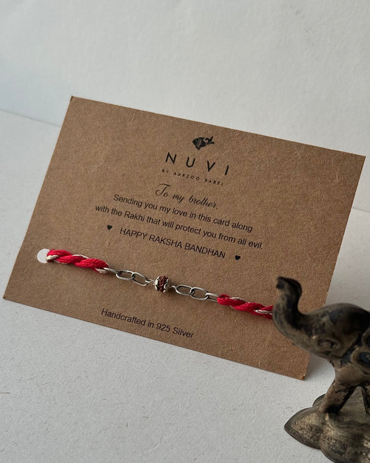 925 Silver Rudraaksh Rakhi with red and white thread on a NUVI branded card a warm message for brother. 