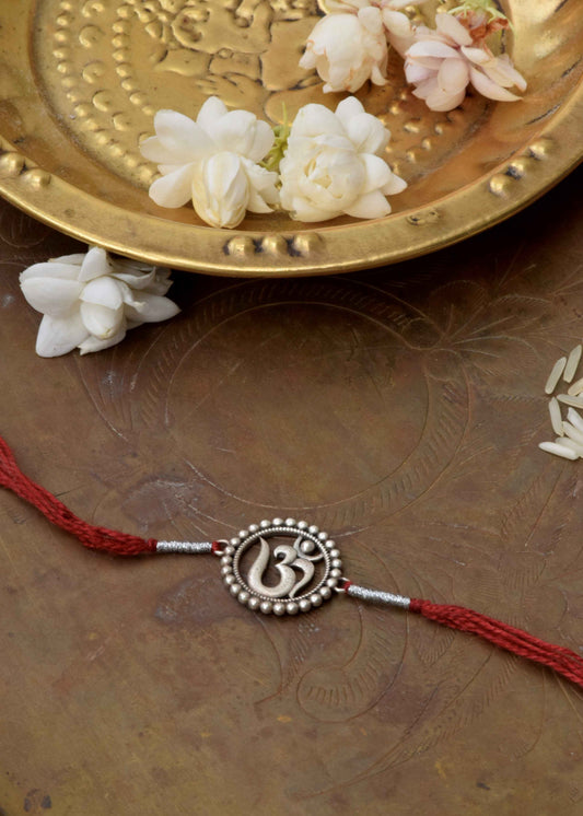  92.5 sterling silver Rakhi crafted with sterling silver and cotton thread.