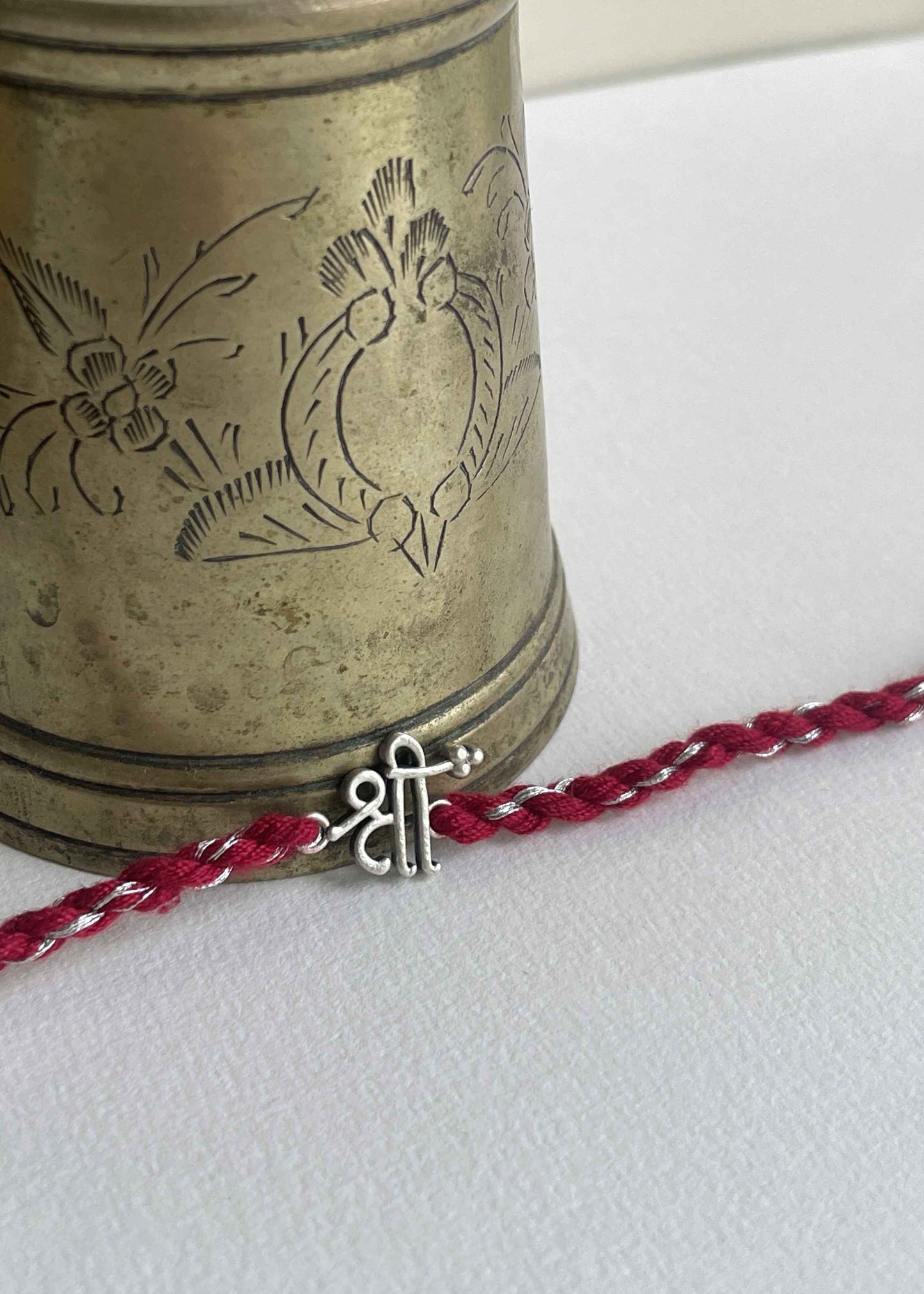 Discover the Shree 925 Sterling Silver Rakhi featuring spiritual symbolism and elegant handcrafted artistry by Nuvi Jewels.