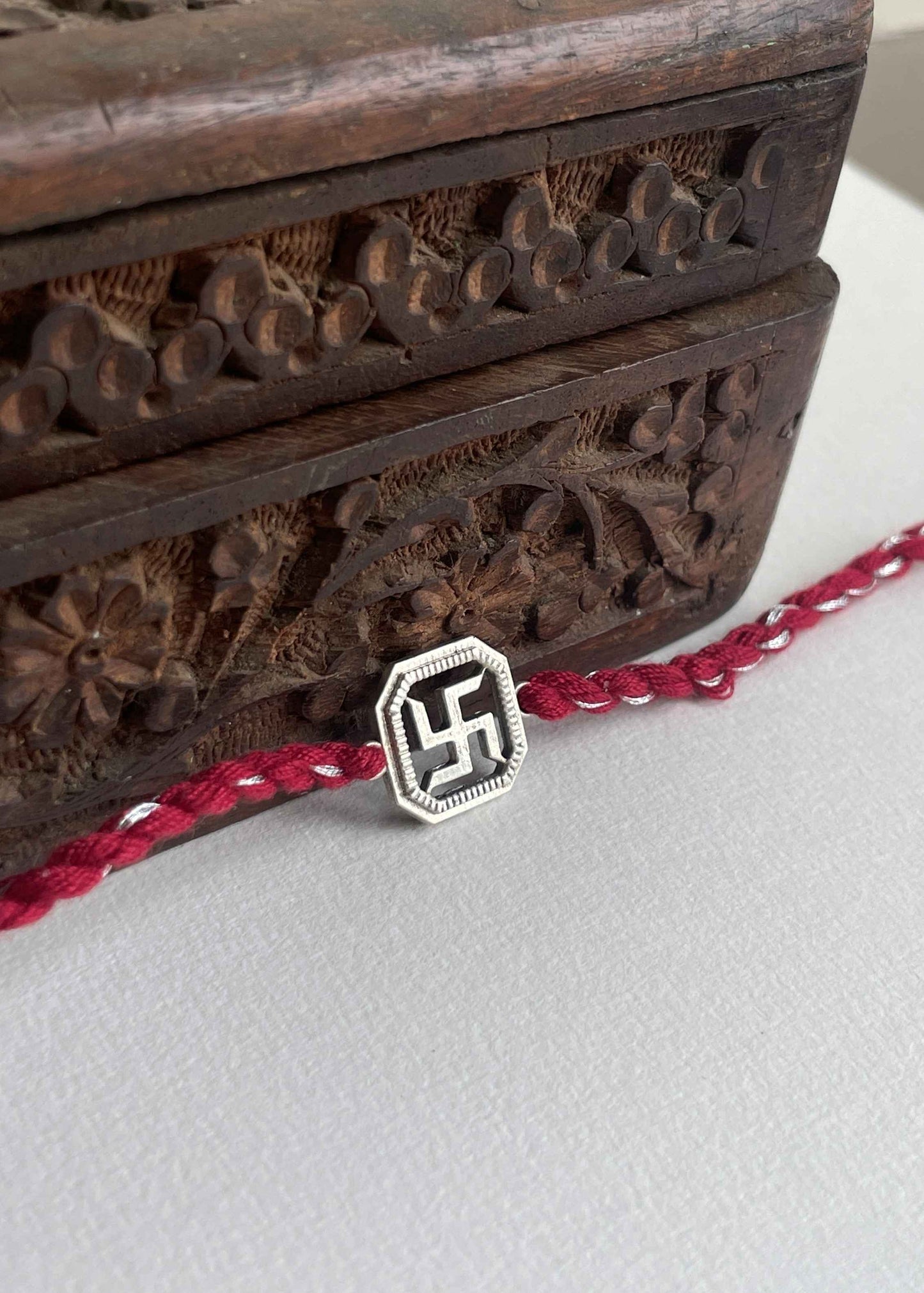Buy Swastik 925 Sterling Silver Rakhi online at Nuvi Jewels. A timeless rakhi blending devotion, tradition, and refined silver craftsmanship.