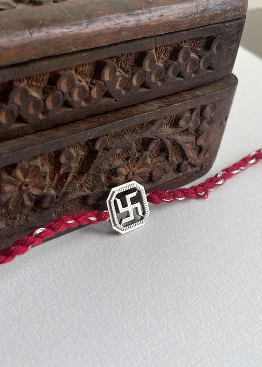 Buy Swastik 925 Sterling Silver Rakhi online at Nuvi Jewels. A timeless rakhi blending devotion, tradition, and refined silver craftsmanship.