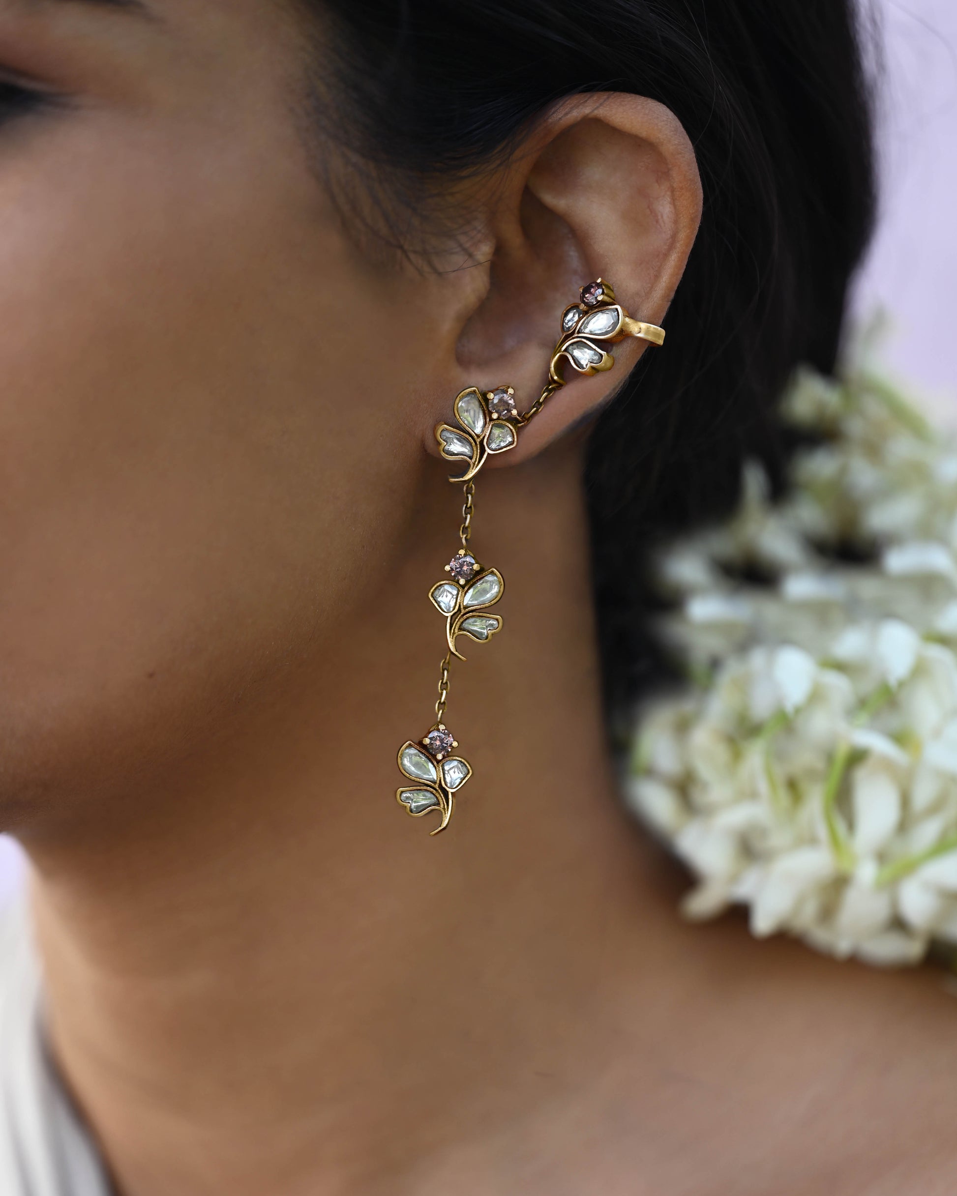 Nuvi Jewels Madhura Earrings in 92.5 silver with four flower motifs, delicate chains, and elegant cuff clip