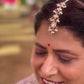 Traditional Indian maangtika in 92.5 silver showcasing intricate jadau craftsmanship and cascading pearl embellishments. Exquisite Handcrafted 925 Silver Jewellery
