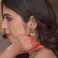 Suratiya Ear Studs handcrafted in 925 silver with radiant gold polish, featuring the traditional chaand-phool motif adorned with Jadau glass-filled stones using the Jadai technique, complemented by delicate pearl drops, green aventurine beads, and a freshwater pearl kaanchain.
