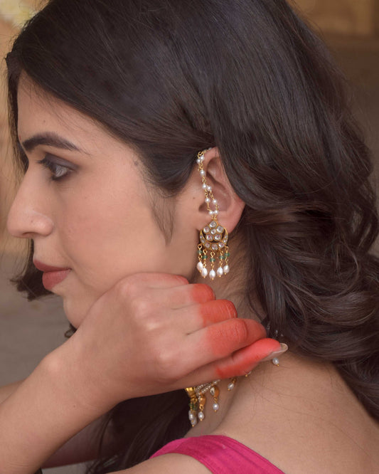 Suratiya Ear Studs handcrafted in 925 silver with radiant gold polish, featuring the traditional chaand-phool motif adorned with Jadau glass-filled stones using the Jadai technique, complemented by delicate pearl drops, green aventurine beads, and a freshwater pearl kaanchain.