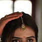 Suratiya Maangtika handcrafted in 925 silver featuring a traditional chaand motif adorned with delicate rice pearls and green aventurine beads.