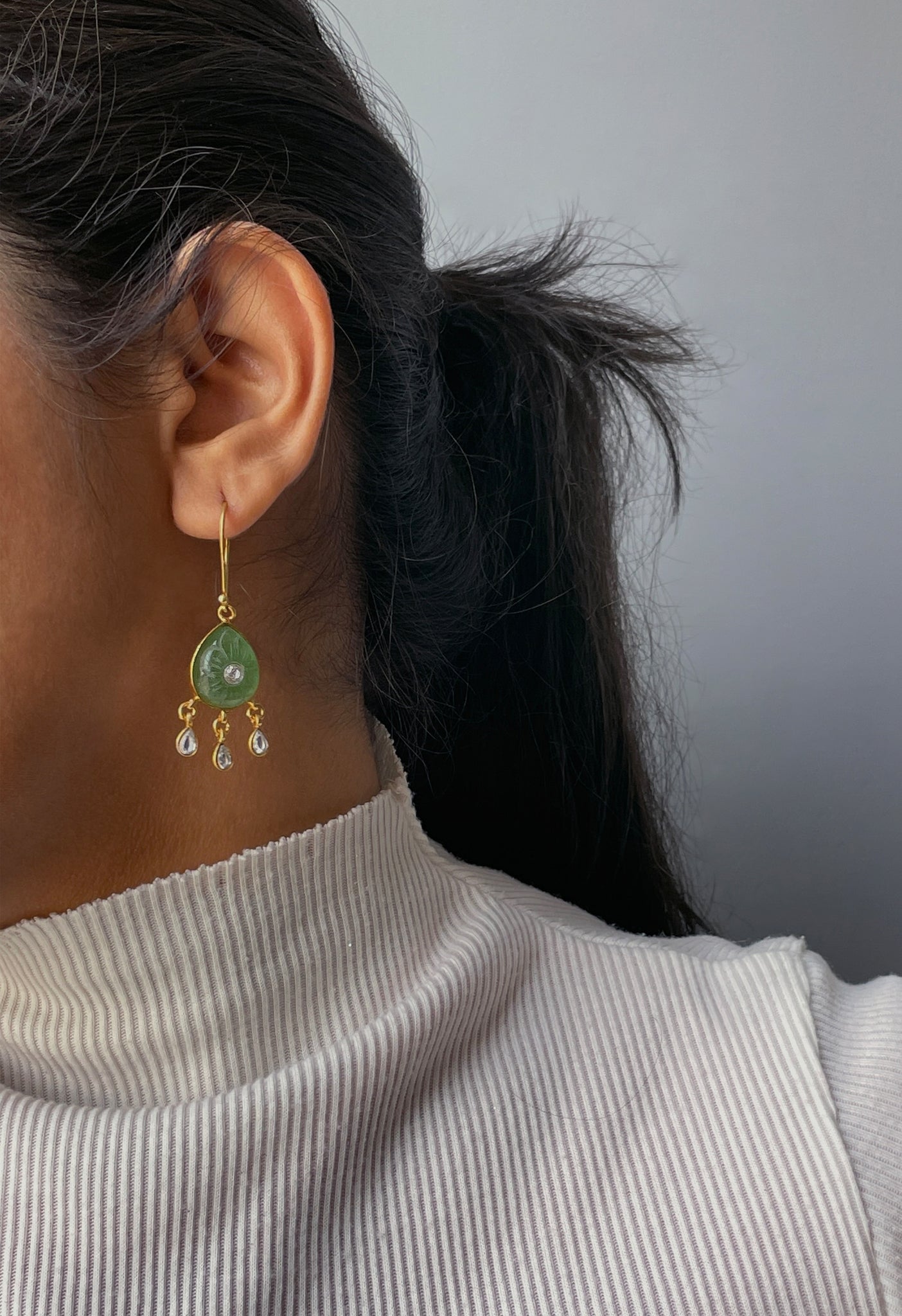 Taranngi Hoop Earrings featuring pear-shaped carved aventurine stones paired with elegant drop-shaped Jadau units.