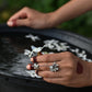 Tarini dual finger ring in 92.5 sterling silver featuring adjustable rings connected by a delicate chain, adorned with floral motifs and jadau stones.