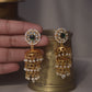 Thumri Jhumkas featuring circular tops adorned with Jadau stones set in 925 silver, bordered with seed pearls, and enhanced by three layers of hanging pearls.
