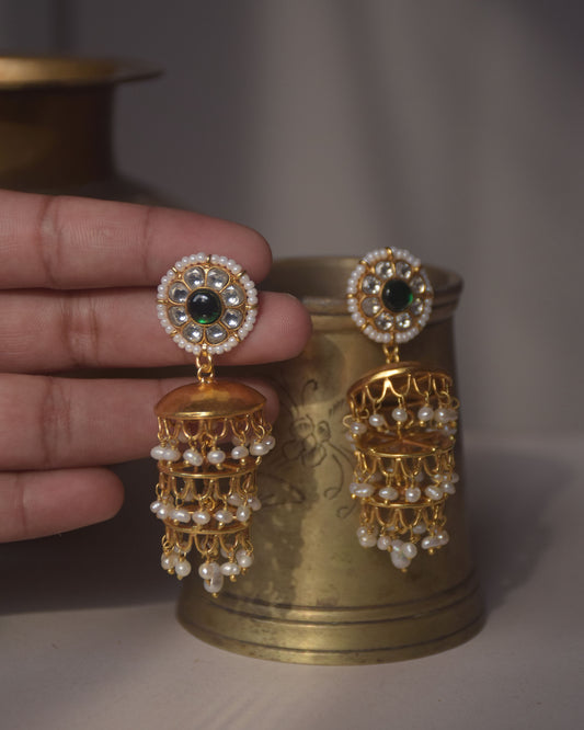 Thumri Jhumkas featuring circular tops adorned with Jadau stones set in 925 silver, bordered with seed pearls, and enhanced by three layers of hanging pearls.